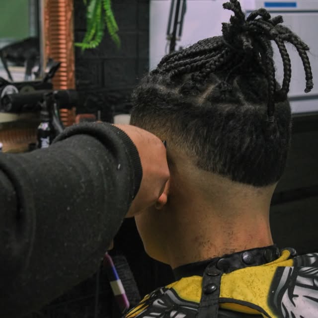 Braids with a sharp low fade, mid-cut in Albufeira