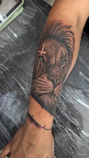 Black and grey realism lion forearm tattoo by MKA Tattoo Albufeira