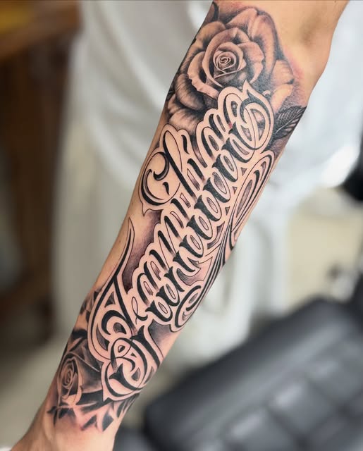 Familia script lettering forearm tattoo with roses